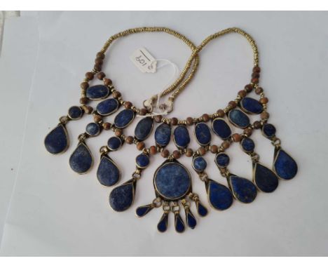 A eastern silver tribal style drop panel necklace with numerous lapis lazuli panels