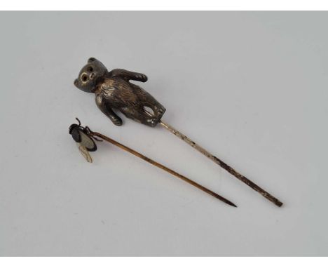 A silver teddy stick pin and bee stick pin