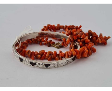 A silver bangle and coral necklace  