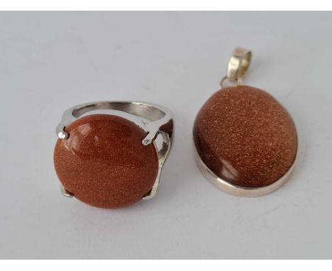 A gold stone pendant and ring