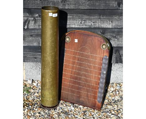 A vintage shove ha'penny board with copper mounts to/w a cylindrical brass ship's shell as a stick stand (2)