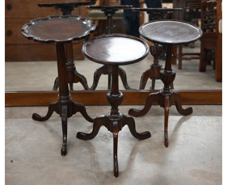 A pair of mahogany circular tripod wine tables, 26 cm diam x 49 cm high to/w scalloped tripod table (3) 