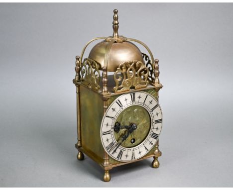 A small traditional brass Smiths lantern style clock, with Roman Numeral engraved silvered dial, the single train movement wi