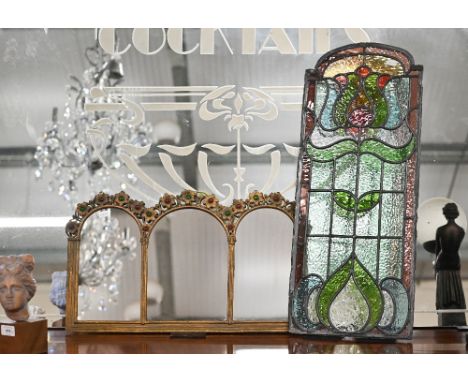 An Art Nouveau leaded stained glass door-panel with stylised floral motif, 72 x 29.5 cm to/w a brass-framed triple-arch wall 