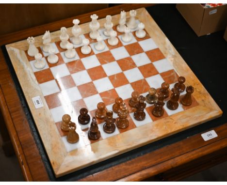 An onyx and marble chessboard with chessmen 