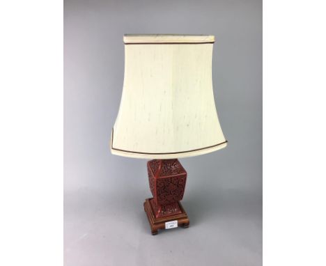 LACQUERED TABLE LAMP, in red, with incised decoration, 27cm high including wooden base