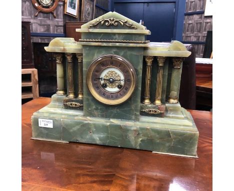 ONYX AND GILT METAL MANTEL CLOCK, with Roman numerals to the dial, with brass and onyx columns, 41cm wide