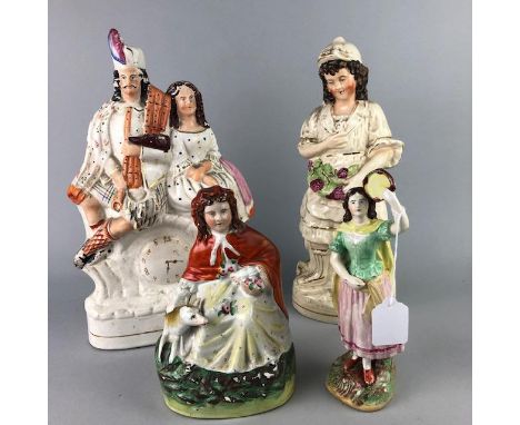 FOUR STAFFORDSHIRE FIGURES, including a figure group with a male and female and a painted clock face, 35.5cm high