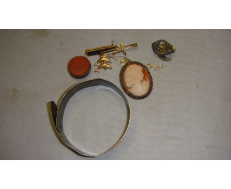 Sterling silver bangle with engine turned decoration, 9 ct gold necklace with dolphin pendant, silver fob, cameo brooch