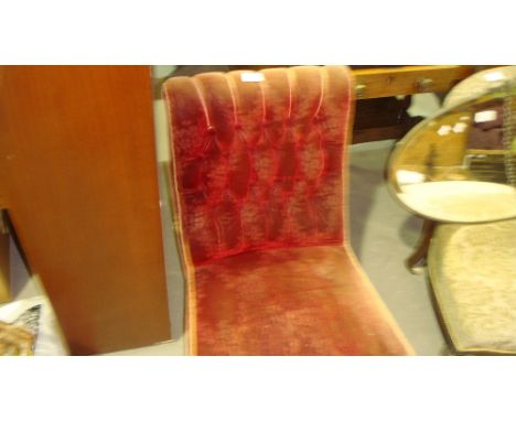 Victorian button back nursing chair with ebonized legs and white china castors
