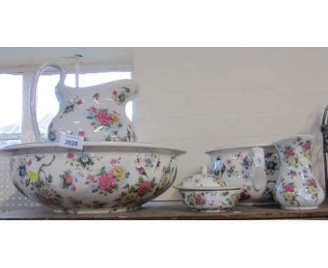 A ceramic bedroom set, comprising wash jug and bowl, chamber pot, vase and soap dish.