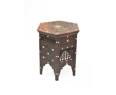 A late 19th century Syrian hardwood, hexagonal occasional table, inlaid in bone with circles and 6-pointed stars, the top car