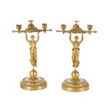 Y A PAIR OF GILT METAL FIGURAL CANDLESTICKS