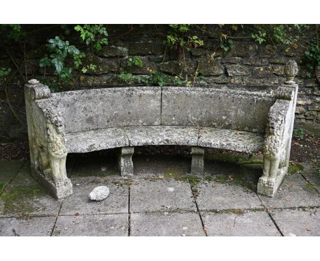 A STONE COMPOSITION GARDEN SEAT  IN VENETIAN TASTE, 20TH CENTURY Of curved 'exedra' form 94cm high, 201cm wide, 55cm deep ove