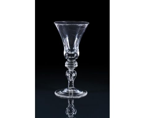 A LARGE BALUSTER GOBLET FIRST QUARTER 18TH CENTURY The thistle shaped bowl withs solid lower section and bead inclusion, supp