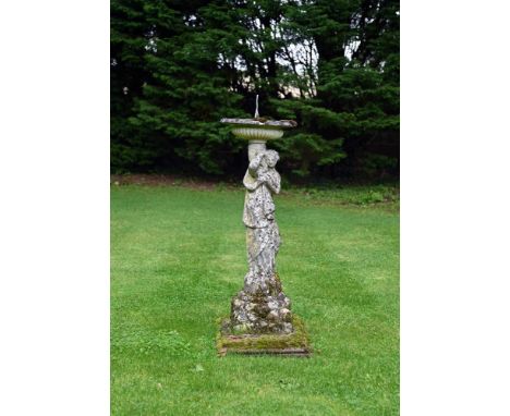 A STONE COMPOSITION SUNDIAL IN THE FORM OF A MAIDEN 20TH CENTURY  With lead sundial 126cm high overall the top 40cm diameterP