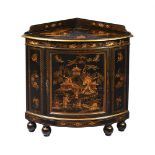 A BLACK LACQUER AND GILT DECORATED CORNER CABINET