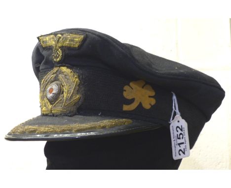 German U-Boat Captains visor cap. The flotilla badge is an original from the period, the cap and bullion badges are post war.