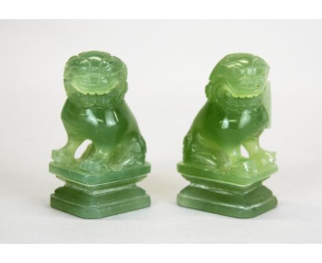 A pair of Chinese carved jade /hardstone figures of liondogs, H. 7cm.