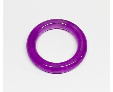 A lavender jade/hardstone bangle, W. 1.5cm, internal Dia. 6cm.
