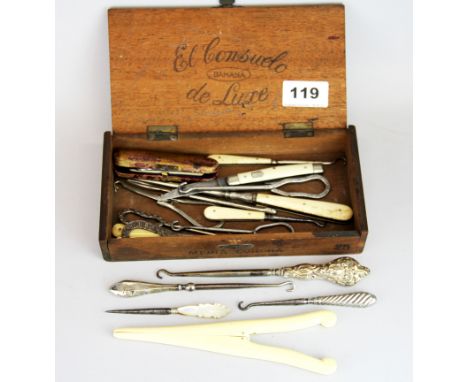 A box of interesting button hooks and glove stretchers.