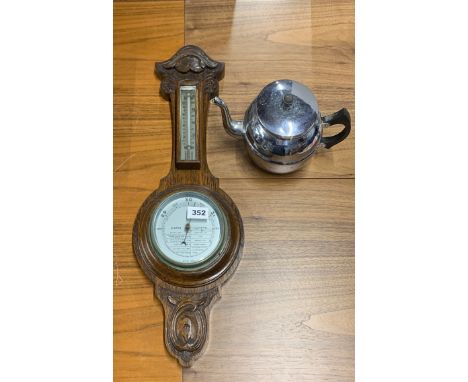 A 1930's carved oak barometer, H. 62cm with a chromium plated teapot.