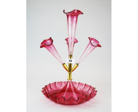 A 19th century cranberry glass and gilt metal epergne with cut glass flutes, H. with flute 40cm.