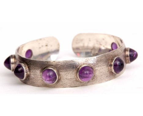 Mid-20th century silvered dog collar style bangle studded with eight quality cabochon amethyst stones