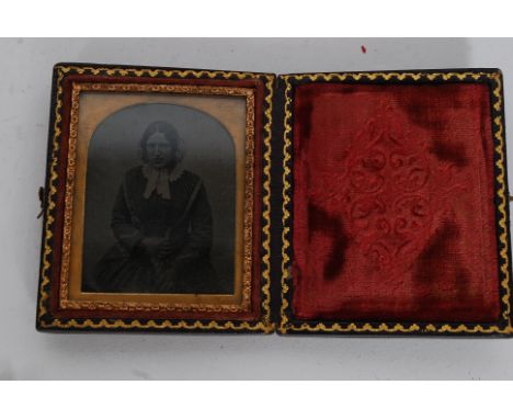 A Victorian daguerreotype portrait miniature in folding leather tooled case of an elderly woman