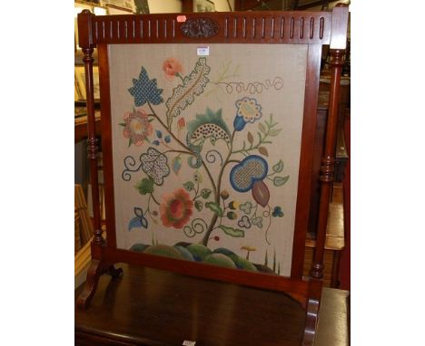 An Edwardian walnut and floral needlework inset fire screen, w.71cm
