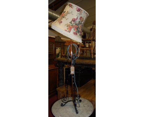 An early 20th century black painted wrought iron and copper standard lamp 