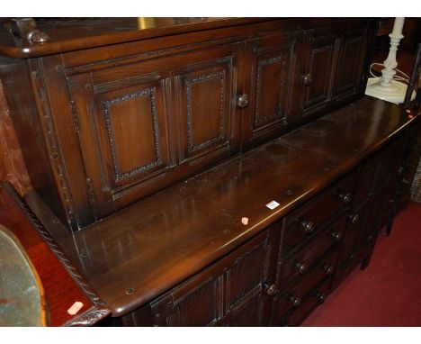 An Ercol dark elm court cupboard, w.146cm 