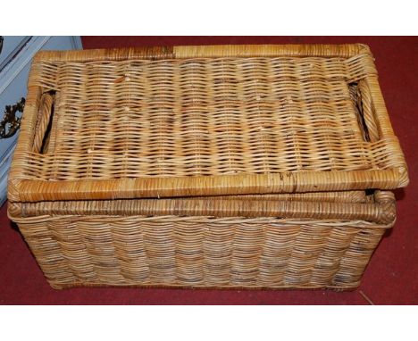 A pair of graduated wicker hamper type boxes