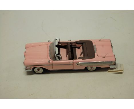 A boxed Franklin Mint 1/24 scale model of a 1958 Edsel Citation finished in pink   Condition Report / Extra Information  Mode