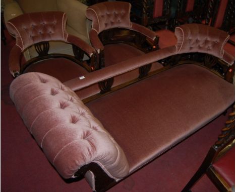 An Edwardian carved walnut framed and button back upholstered parlour suite comprising; daybed and pair of tub armchairs (3)