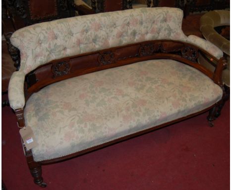 A late Victorian walnut and floral upholstered buttonback two-seater salon sofa, w.143cm 