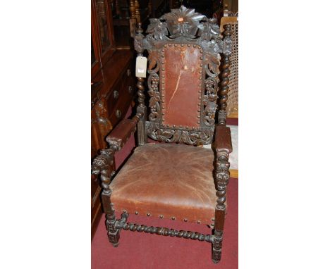 A set of six late 19th century heavily carved oak dining chairs, each having a green mask carved top rail with further vining