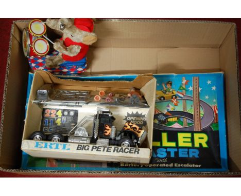 A quantity of mixed children's boxed and loose toys to include an Ertl Big Pete Racer Truck, a tinplate and battery operated 