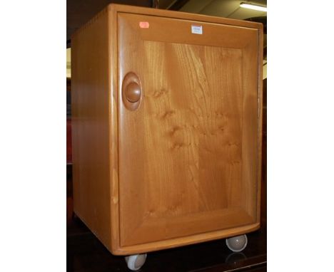 A small Ercol blond elm single door side cupboard, on castors, w.46.5cm 