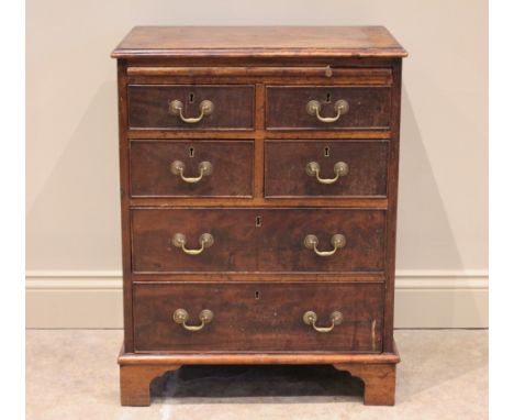 A George III mahogany chest, of cottage proportions, the rectangular moulded top above a brushing slide and an arrangement of