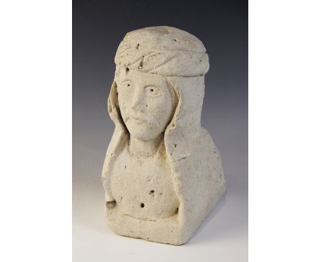 A carved stone corbel depicting the bust of a noble gentleman with moustache and headdress, 31cm high (at fault)&nbsp;