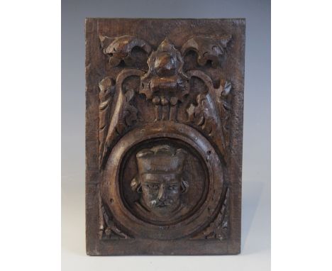 A Henry VIII carved oak panel, Tudor, 15/16th century, Romayne type, carved with a male portrait with an ornate hat, below po