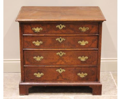 An early 18th century and later, figured walnut bachelors chest, the rectangular quarter veneered and feather banded top with