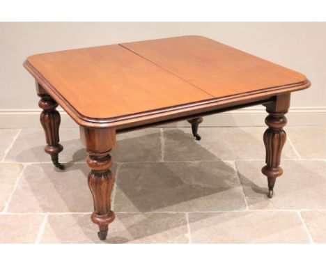 * A Victorian mahogany extending dining table, the rectangular top with rounded corners and a moulded edge, above a plain fri