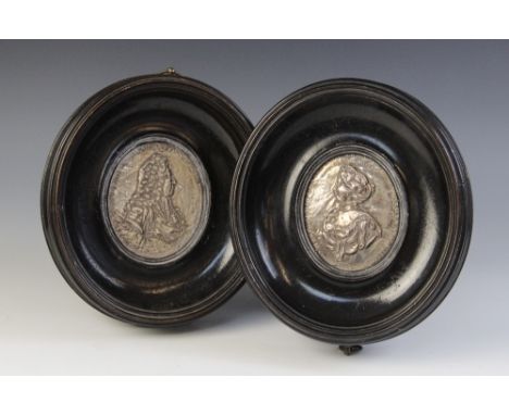 A pair of silver coloured William & Mary commemorative plaques,18th Century,Depicting repoussé profile busts of each monarch,