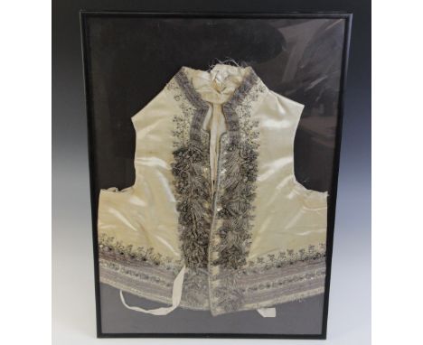 A late 18th/early 19th century ivory silk satin waistcoat, decorated in silver coloured and gilt brocade with trefoil embroid