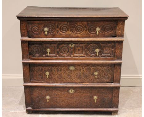 A carved oak chest of drawers, 17th century and later constructed, the three board top with incised initials 'H R', above fou