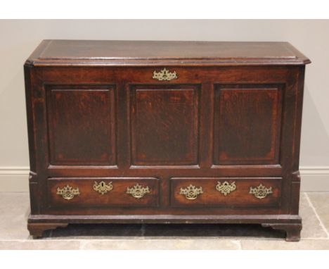 A George III oak and mahogany crossbanded mule chest, the rectangular top with canted front corners opening to a candle box a