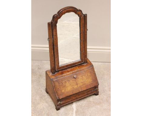 A George I cross banded walnut dressing table mirror, the arched Dutch style swing mirror above a fall front opening to a fit