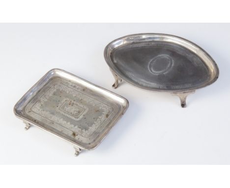 A George III silver teapot stand, Thomas Chawner, London 1783, of oval form on four raised feet with engraved decoration and 